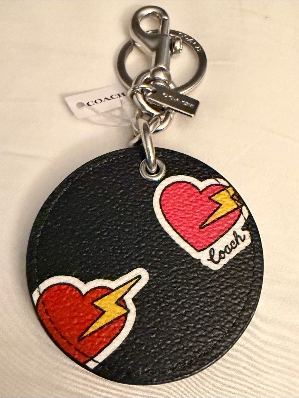 Coach Mirror Bag Charm with Heart Bolt.